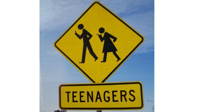 teenagers-road-sign-texting-supplied